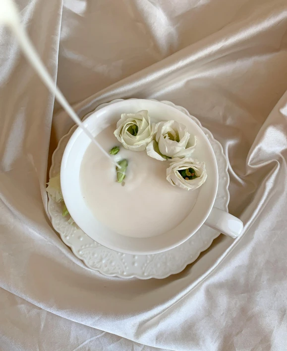 a close up of a plate with flowers on it, a 3D render, inspired by Jean-Marc Nattier, unsplash, hot cocoa drink, candle dripping white wax, soft white rubber, white hanfu