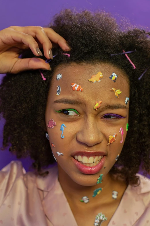 a woman with a lot of confetti on her face, an album cover, inspired by Howardena Pindell, trending on pexels, puffy sticker, black teenage girl, made out of sweets, character close-up