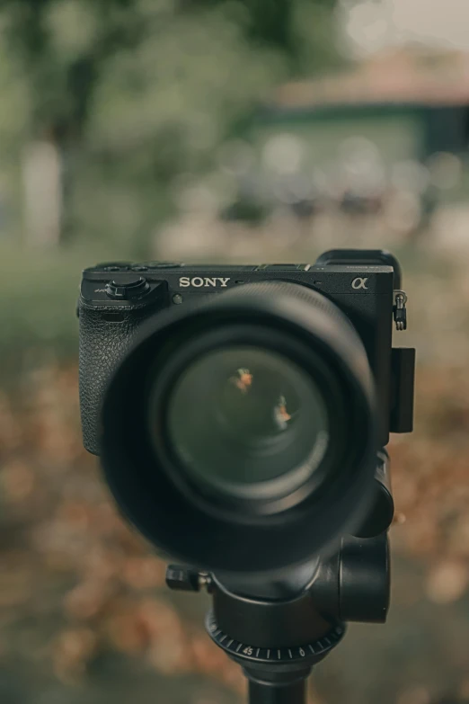 a close up of a camera on a tripod, shot with sony alpha 1 camera, blurry footage, front facing camera, blurry image