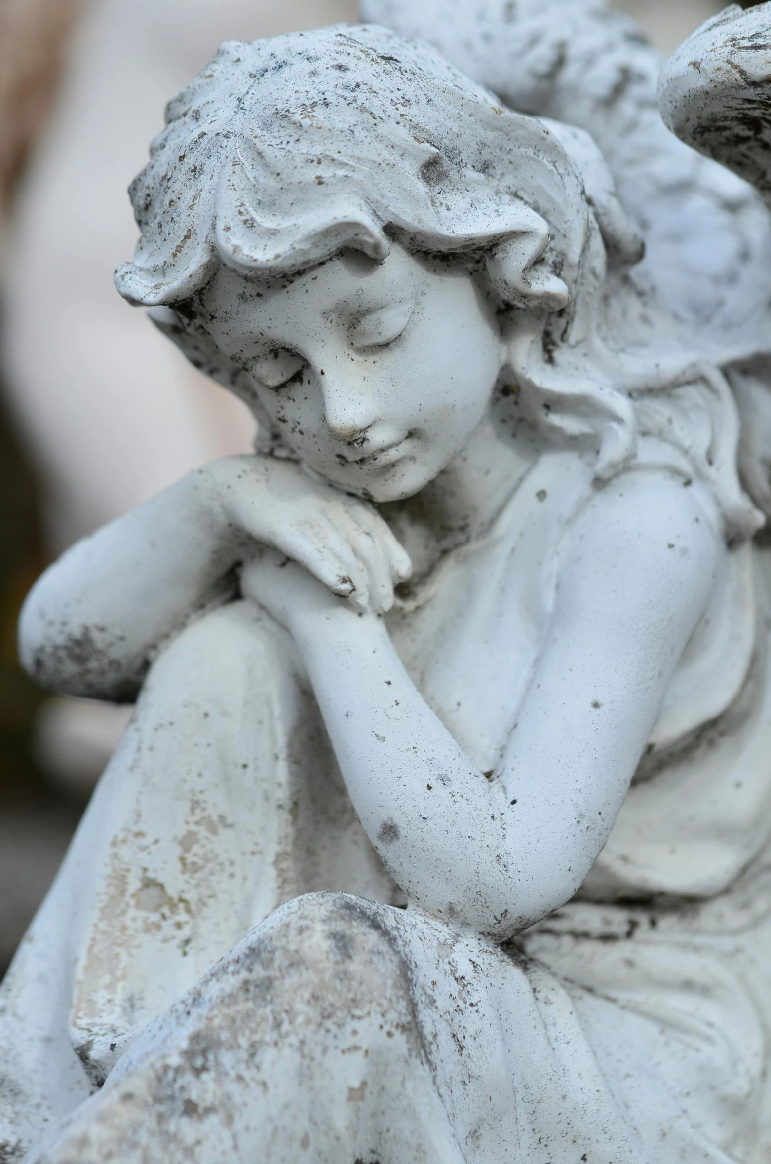 a close up of a statue of an angel, resting head on hands, sitting down, walking down, sad face