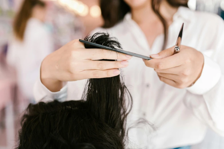 a woman cutting another woman's hair with scissors, by Nicolette Macnamara, trending on pexels, hurufiyya, rectangle, detailed long black hair, no - text no - logo, professionally taken