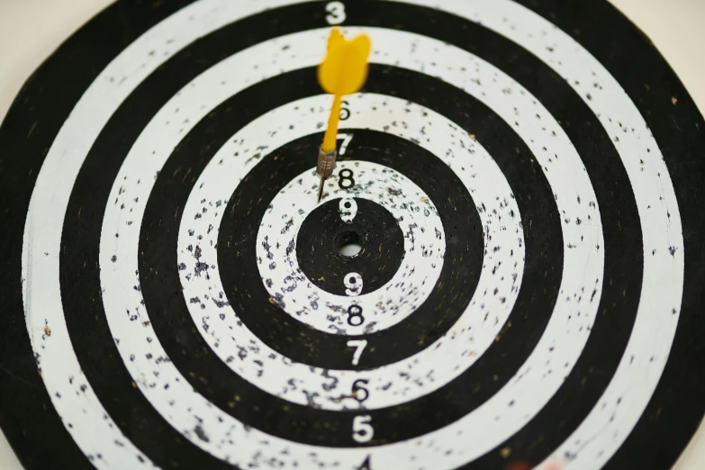 a dart hitting in the center of a black and white target, pexels, instagram post, centered design, 1 2 9 7, circles