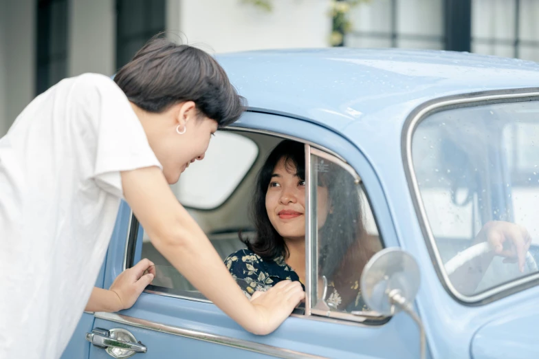 a woman looking out the window of a blue car, pexels contest winner, smiling at each other, a young asian woman, 15081959 21121991 01012000 4k, vintage car