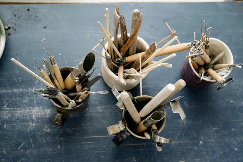 a group of utensils sitting on top of a table, inspired by Sarah Lucas, unsplash, process art, vessels, stems, brush art, studio bones