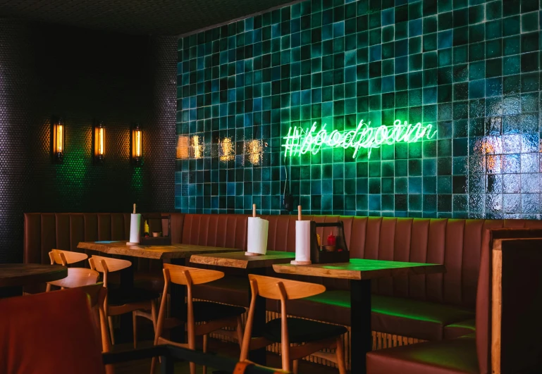 a restaurant with a neon sign on the wall, unsplash, altermodern, tiled room squared waterway, ripley scott, green neon, profile image