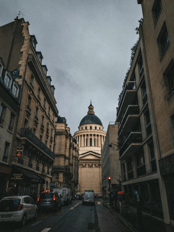 a street lined with tall buildings next to tall buildings, a photo, pexels contest winner, paris school, neoclassical tower with dome, saintly, moody details, pantheon