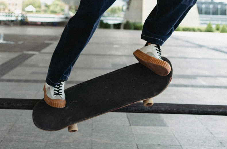 a person doing a trick on a skateboard, pexels contest winner, fan favorite, commercial banner, benches, rubber waffle outsole