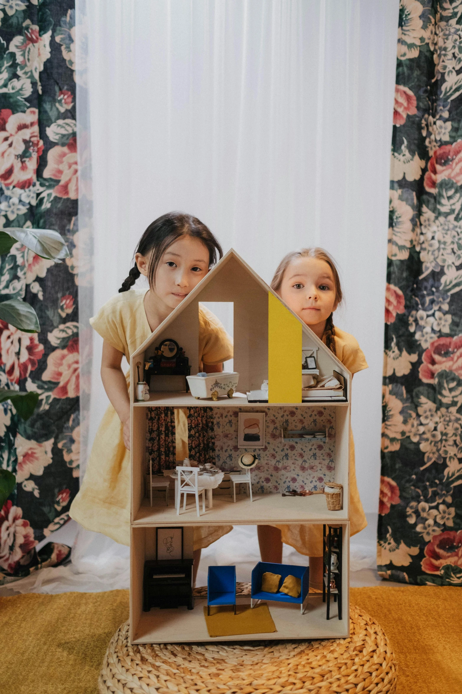 two little girls standing in front of a doll house, by Juliette Leong, unsplash, made of cardboard, floral, ikea, promotional image