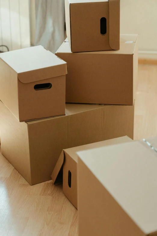 a pile of cardboard boxes sitting on top of a hard wood floor, thumbnail, decorations, multiple stories, order