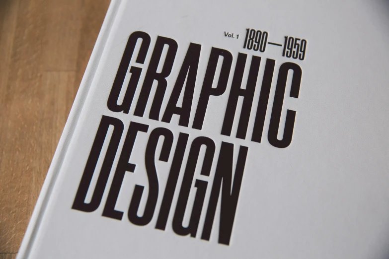 a book sitting on top of a wooden table, behance, international typographic style, '2d graphic design, set in 1 8 5 0, graphite, logo has”