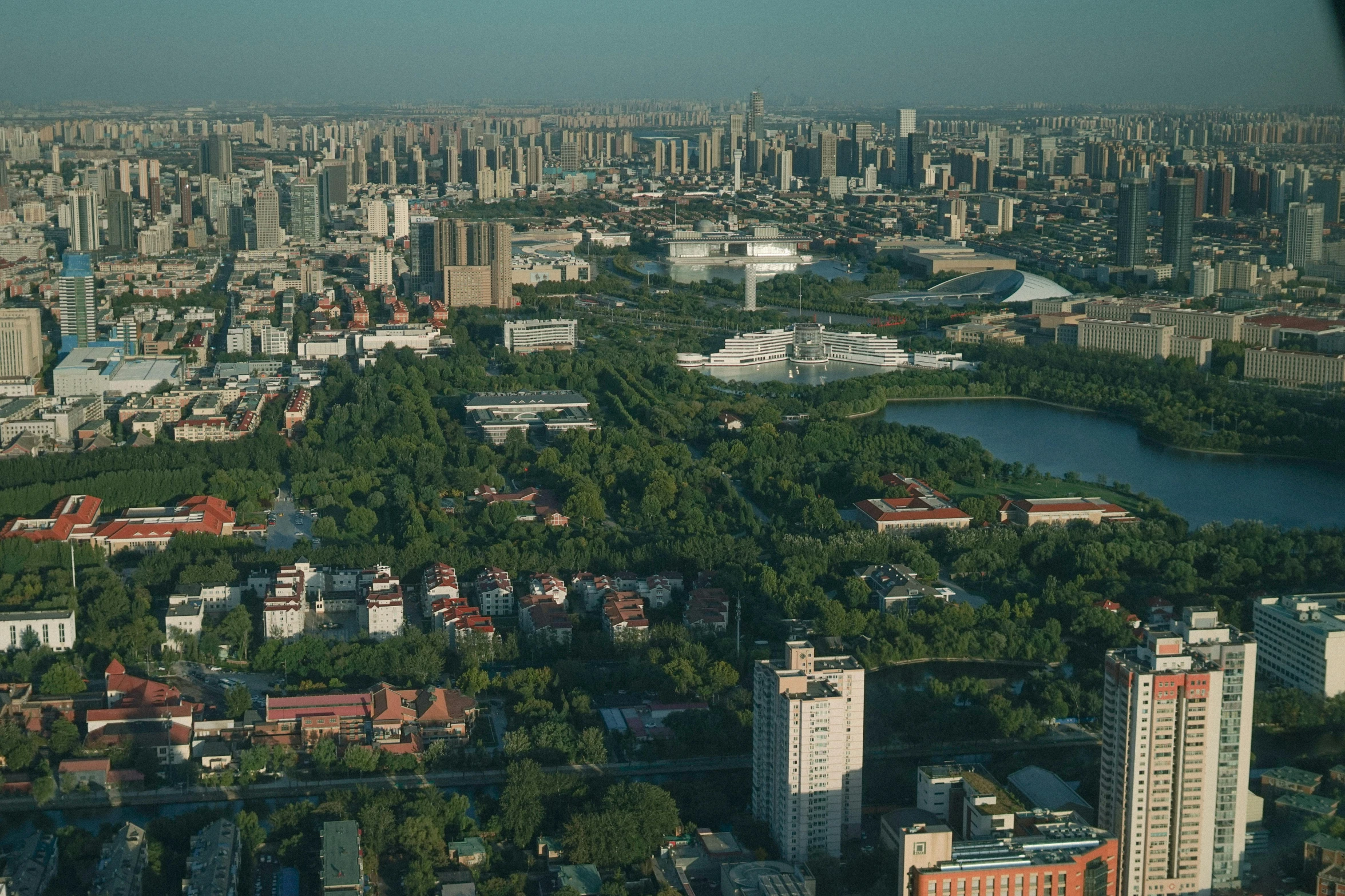 a view of a city from a plane, inspired by Shi Zhonggui, pexels contest winner, hyperrealism, parks and lakes, wide establishing shot, beijing, slide show