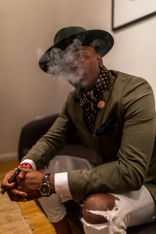 a man sitting on a couch smoking a cigarette, inspired by Theo Constanté, pexels contest winner, harlem renaissance, green suit and bowtie, spiral smoke, handsome hip hop young black man, profile picture