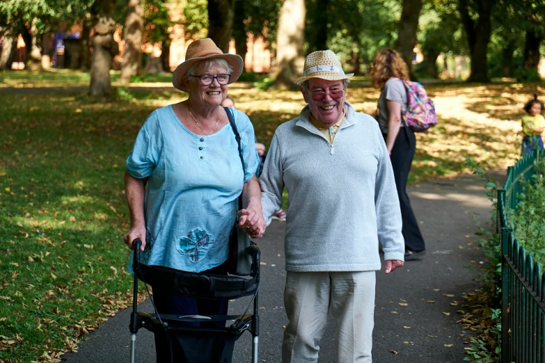 a couple of older people walking down a path, a portrait, by Ruth Abrahams, shutterstock, park in background, avatar image, both smiling for the camera, 15081959 21121991 01012000 4k