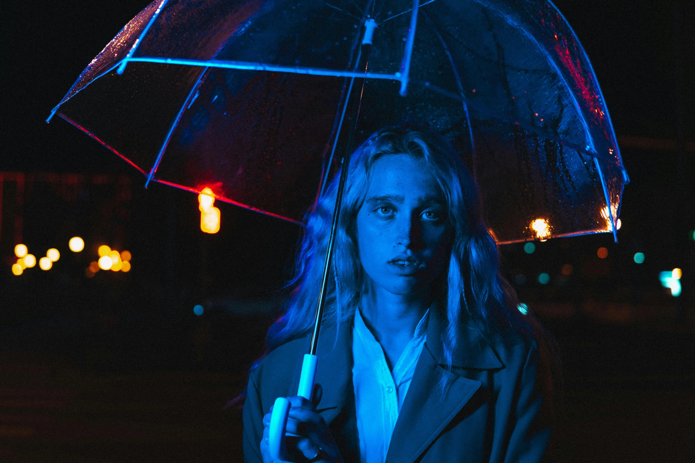 a woman holding an umbrella in the dark, a portrait, inspired by Elsa Bleda, unsplash contest winner, magic realism, portrait of kim petras, blue and red lights, julia garner, film still promotional image