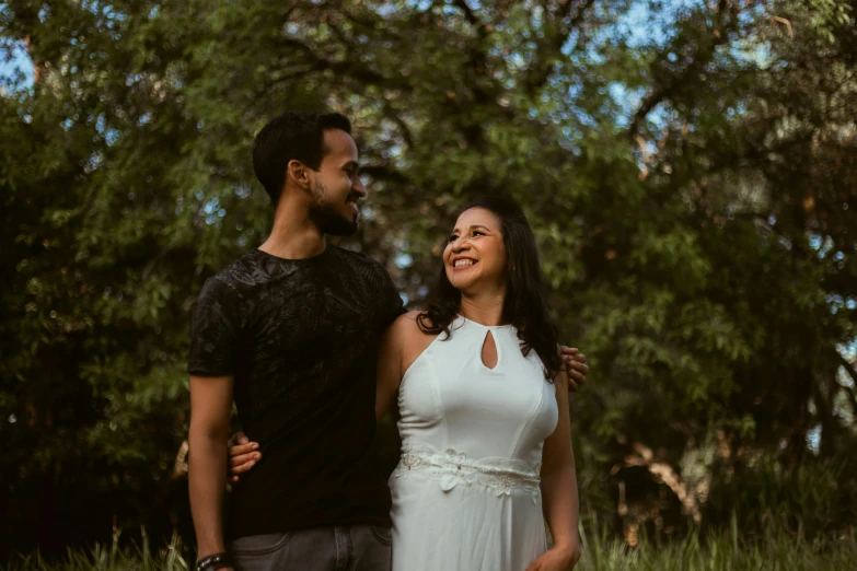 a man and a woman standing next to each other, a picture, pexels contest winner, hispanic, background image, lush surroundings, celebrating