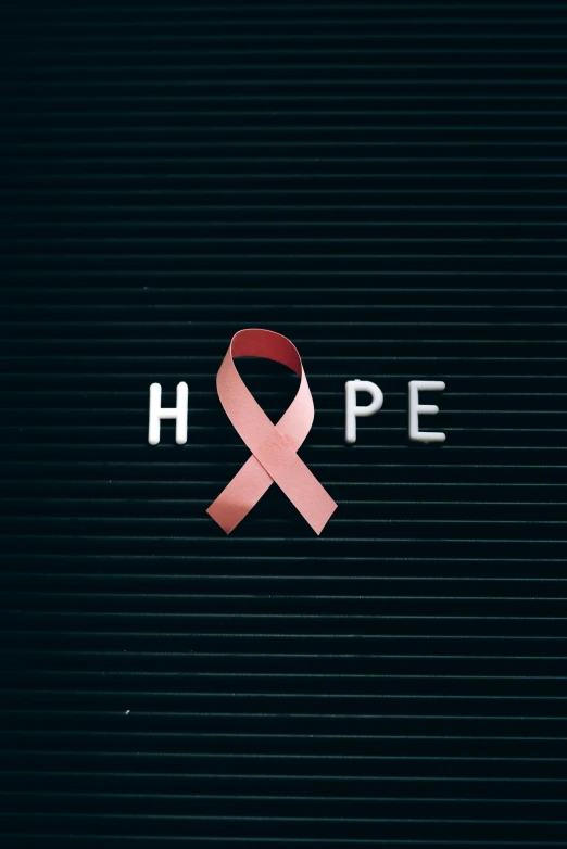 a pink ribbon with the word hope on it, an album cover, pexels, happening, 2 5 6 x 2 5 6, lone survivor, paul barson, a car