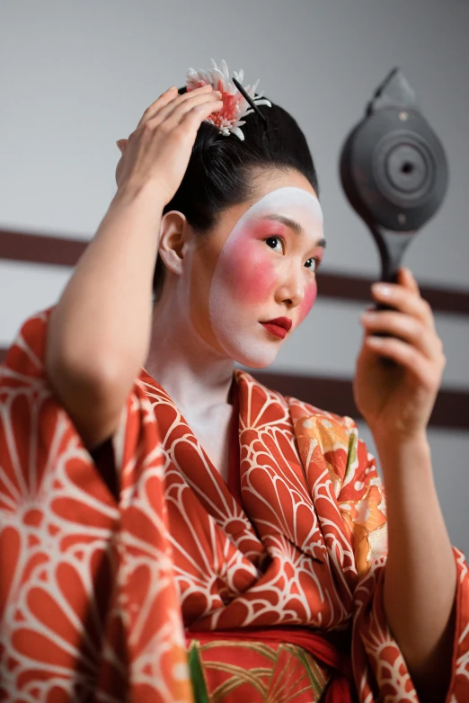 a woman in a kimono is combing her hair, a portrait, inspired by Otake Chikuha, trending on unsplash, bodypaint, ( ( theatrical ) ), square, slide show