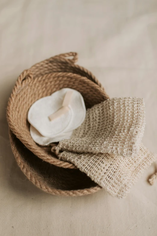 a pile of towels sitting on top of a table, by Nina Hamnett, unsplash, renaissance, holding mesh bag with bagels, clay material, close-up product photo, soft pads