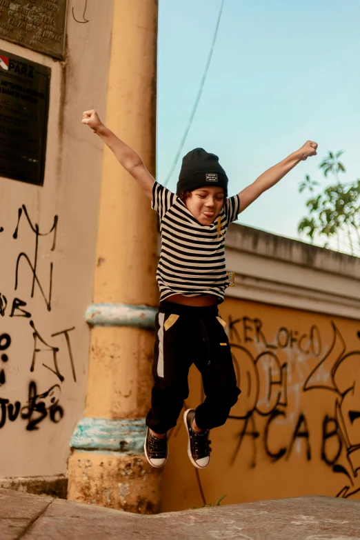 a young man flying through the air while riding a skateboard, an album cover, pexels contest winner, graffiti, peruvian boy looking, happy kid, brazil, still from film