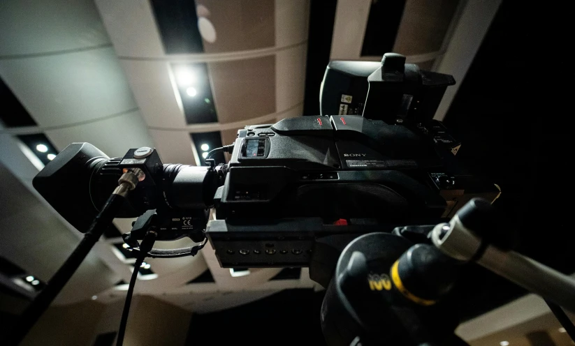 a close up of a camera on a tripod, tv studio, taken with sony alpha 9, camera looking down upon, sci - fi equipment