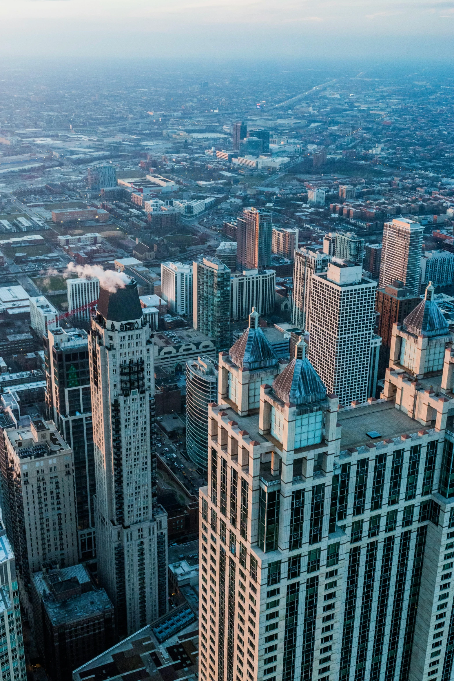 a view of a city from the top of a skyscraper, by Greg Rutkowski, chicago skyline, majestic spires, high quality photo, multiple stories