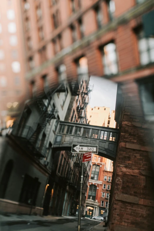 a red stop sign sitting on the side of a road, a picture, by Nina Hamnett, unsplash contest winner, new york alleyway, city reflection, unfocused, tenement buildings
