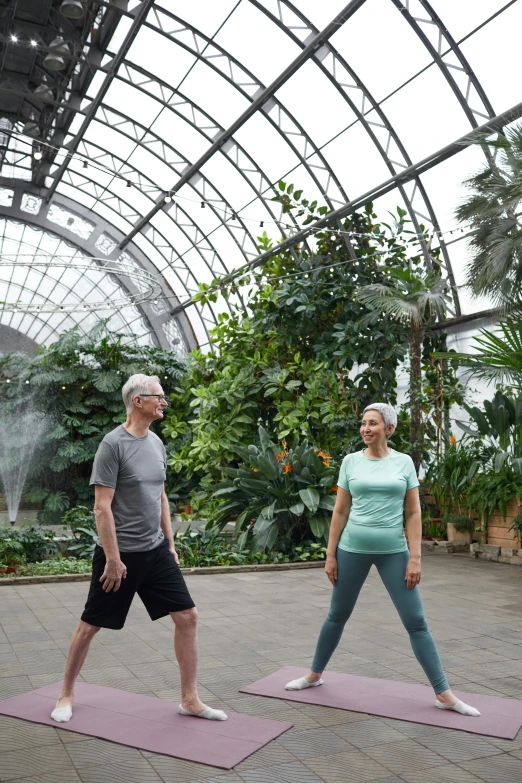 a man and a woman doing yoga together, inspired by Graham Forsythe, huge greenhouse, walking, biodome, active