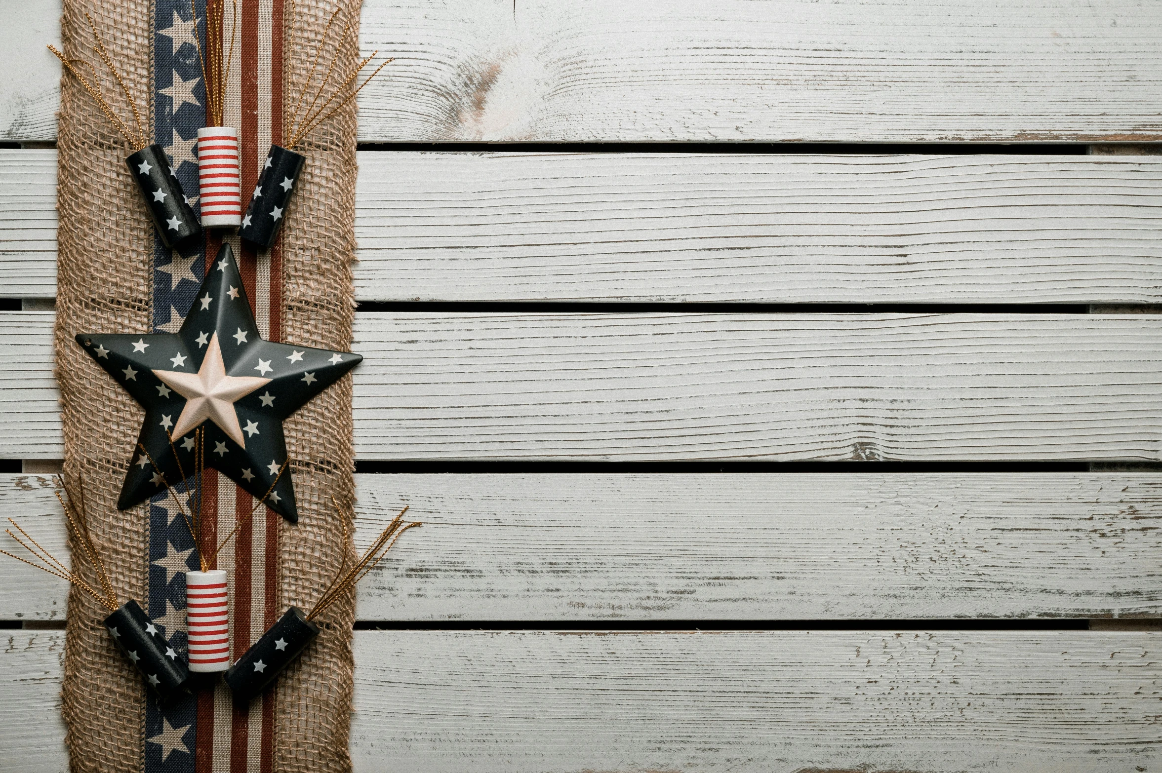 an american flag hanging on the side of a wooden wall, pexels contest winner, various items, background image, burlap, starry