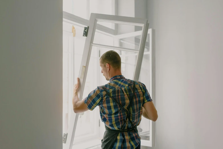 a man that is standing in front of a window, quick assembly, profile image, tilted 35° frame, maintenance