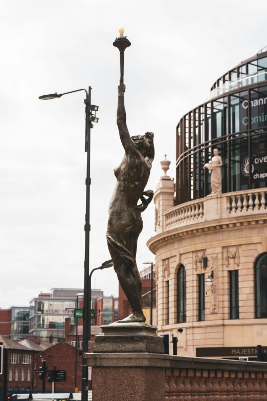 a statue of a woman holding a tennis racquet, a statue, inspired by Sir Jacob Epstein, unsplash, hull is a opera house, walking to the right, exterior view, victor horta