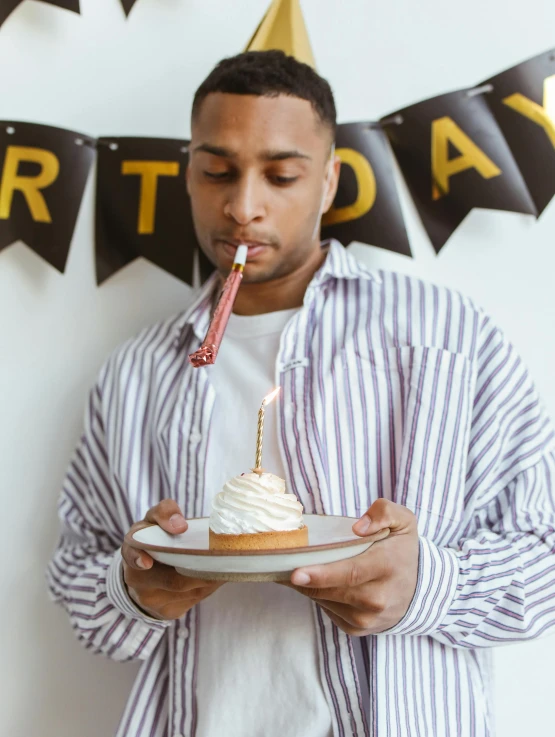 a man blowing out a candle on a birthday cake, by Carey Morris, trending on unsplash, renaissance, wearing stripe shirt, handsome hip hop young black man, holding a candle holder, thumbnail