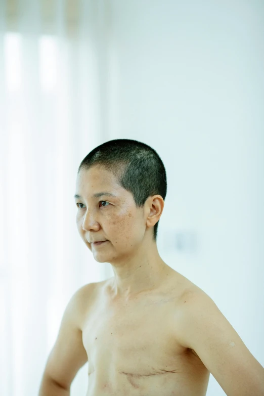 a man with no shirt standing in front of a mirror, a tattoo, inspired by Zhang Kechun, unsplash, hyperrealism, older woman, shaved hair, profile image, cai guo-qiang