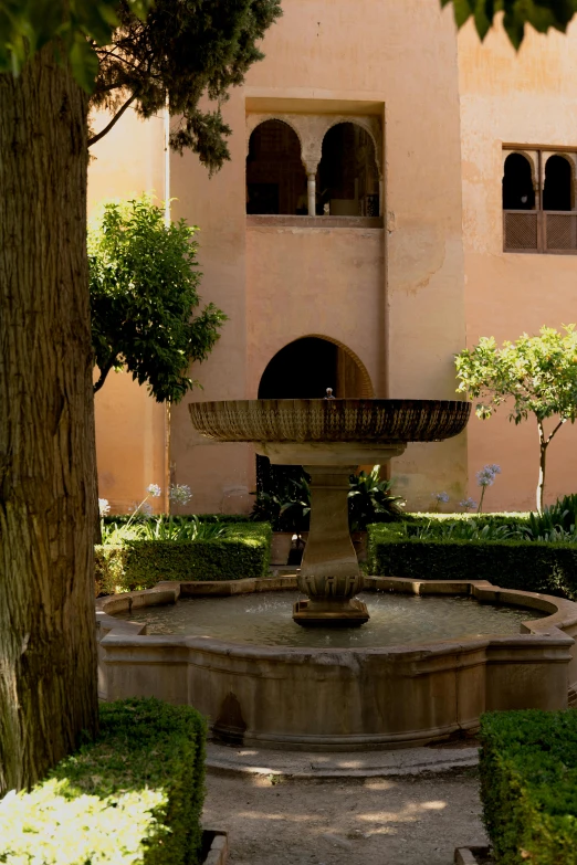 a fountain in the middle of a garden, a statue, inspired by Luis Paret y Alcazar, courtyard walkway, marrakech, seen from the side, well shaded