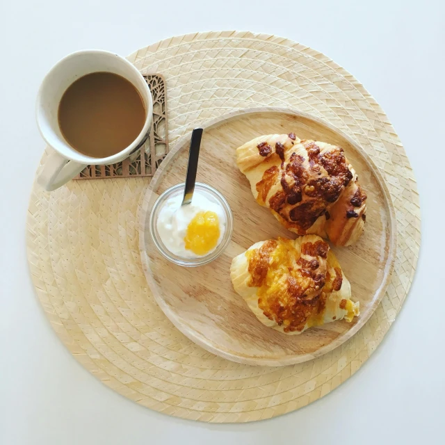 a plate topped with pastries next to a cup of coffee, by Adriaen Hanneman, pexels contest winner, minimalism, on a wooden plate, ham, honey, 64x64