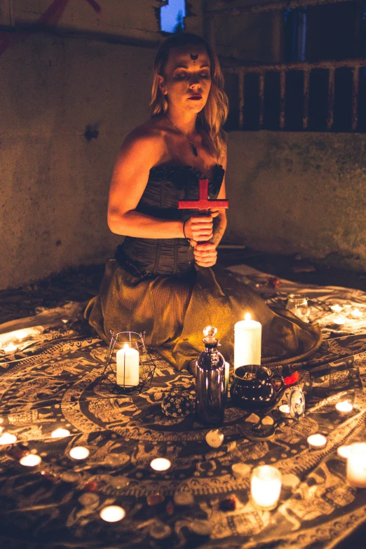 a woman sitting on a rug surrounded by candles, pexels contest winner, renaissance, holding a sacrificial dagger, witchy clothing, light show, mid body shot