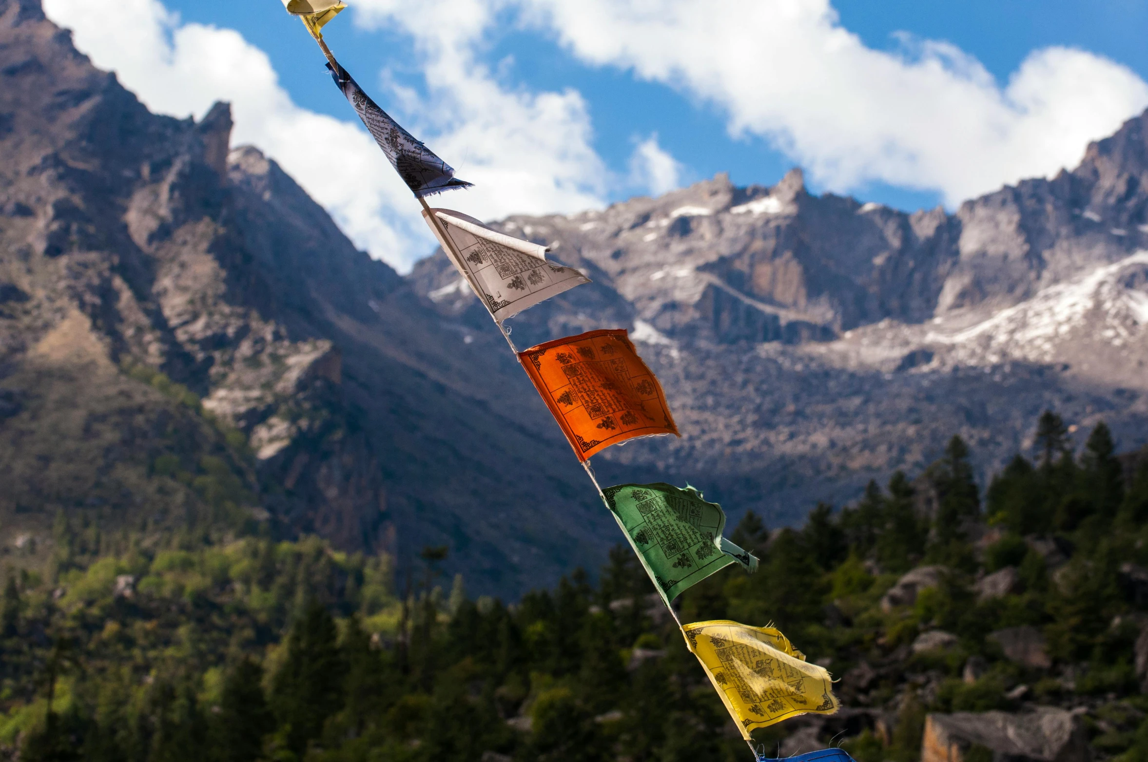 a group of flags hanging from the side of a mountain, an album cover, unsplash, bhutan, square, in the dolomites, profile image