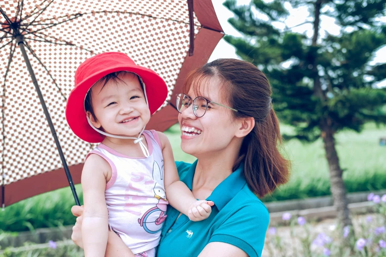 a woman holding a little girl under an umbrella, inspired by Cui Bai, pexels contest winner, happily smiling at the camera, avatar image, korean, profile image