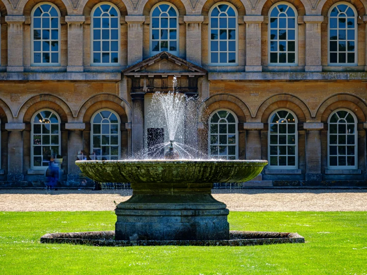 a fountain in front of a large building, inspired by William Hoare, pexels contest winner, lawn, no cropping, bath, commercially ready