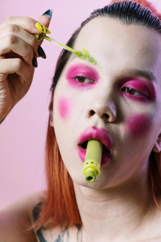 a woman with pink makeup is brushing her teeth, an album cover, inspired by Russell Dongjun Lu, trending on pexels, eating alien food, lesbians, green saliva, mustard