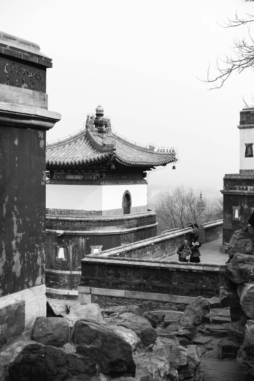 a black and white photo of a pagoda, a black and white photo, inspired by Wen Zhengming, happening, palace on top of the hill, over the shoulder view, beijing, archs and walls