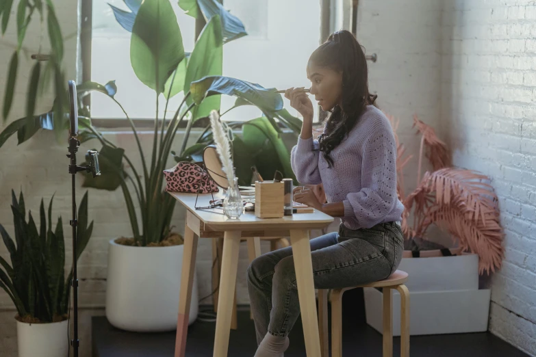 a woman sitting at a table in front of a window, trending on pexels, hyperrealism, terrarium lounge area, background image, sydney park, drinking a strawberry iced latte