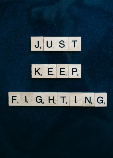scrabbles spelling just keep fighting on a blue background, an album cover, by Jesper Knudsen, unsplash, 256435456k film, ultimate fighting championship, unedited, fighters