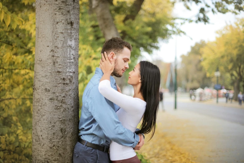 a man and a woman leaning against a tree, by Niko Henrichon, pexels contest winner, realism, kissing together cutely, 15081959 21121991 01012000 4k, attractive man, october