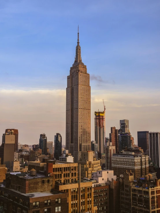 the empire state building towering over the city of new york, unsplash contest winner, renaissance, 2 0 2 2 photo, slide show, frank lloyd wright, splash image