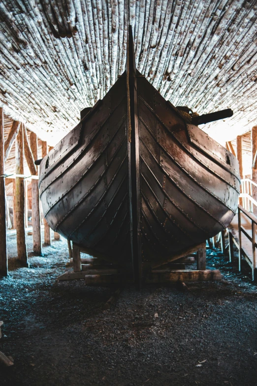 a boat that is sitting inside of a building, inspired by Þórarinn B. Þorláksson, unsplash contest winner, renaissance, inside a barn, shipyard, full frame image, in an attic