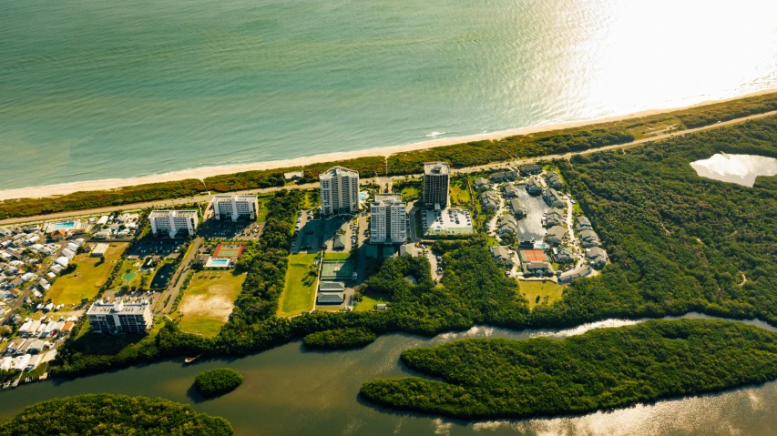 a large body of water next to a beach, happening, complex buildings, sun coast, green spaces, satelite imagery