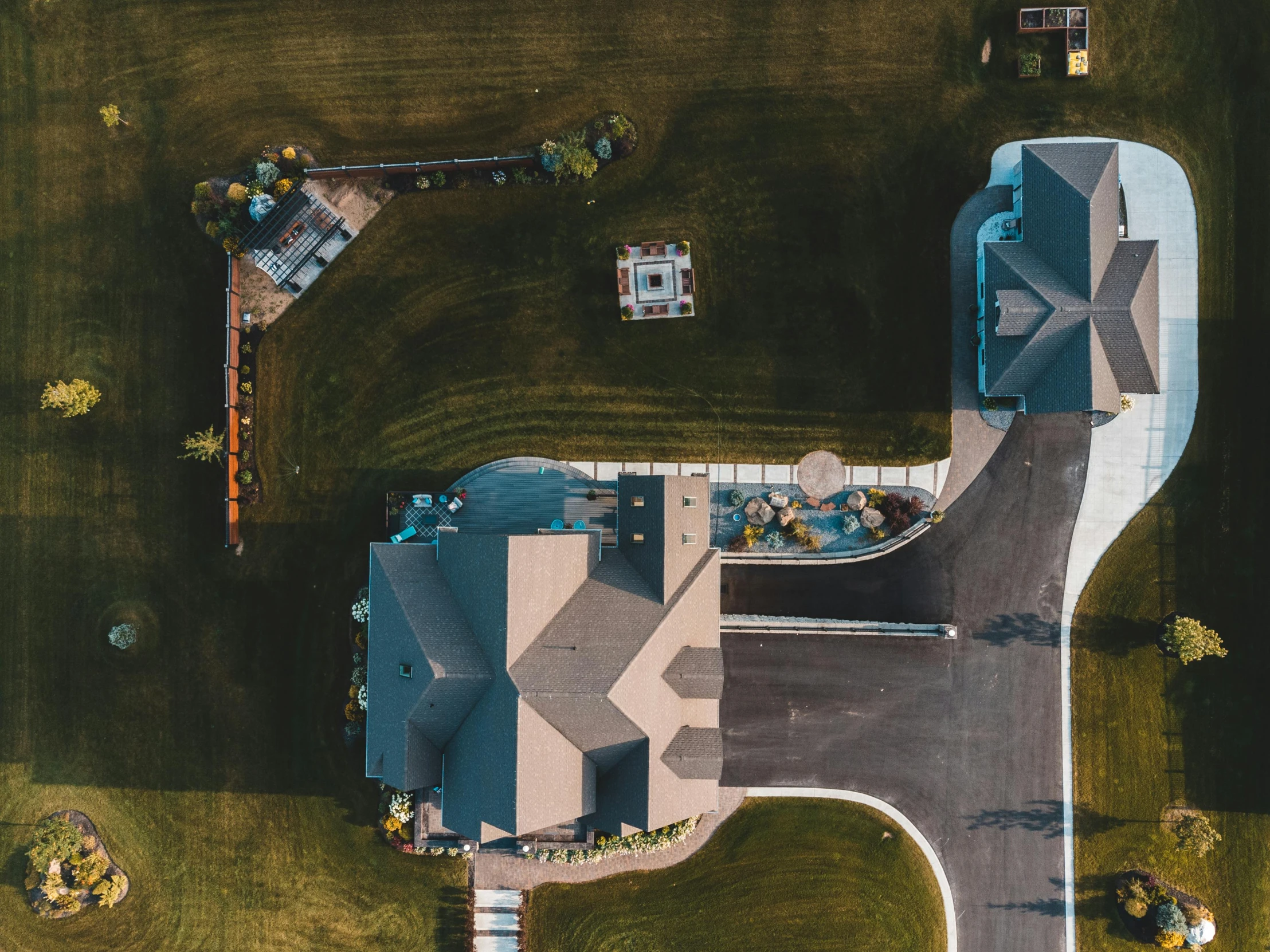 a large house sitting on top of a lush green field, a screenshot, pexels contest winner, high angle security camera feed, driveway, well built, hyperdetailed photo