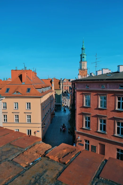 a view of a city from the top of a building, inspired by Aleksander Orłowski, pexels contest winner, red castle in background, common street, poland, profile image