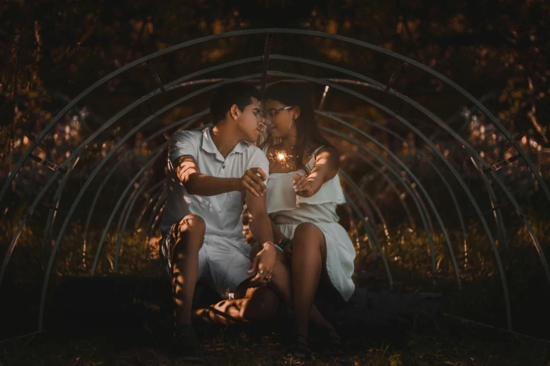 a man and woman sitting in a tunnel holding sparklers, a picture, pexels contest winner, romanticism, avatar image, lovely kiss, hispanic, slightly pixelated