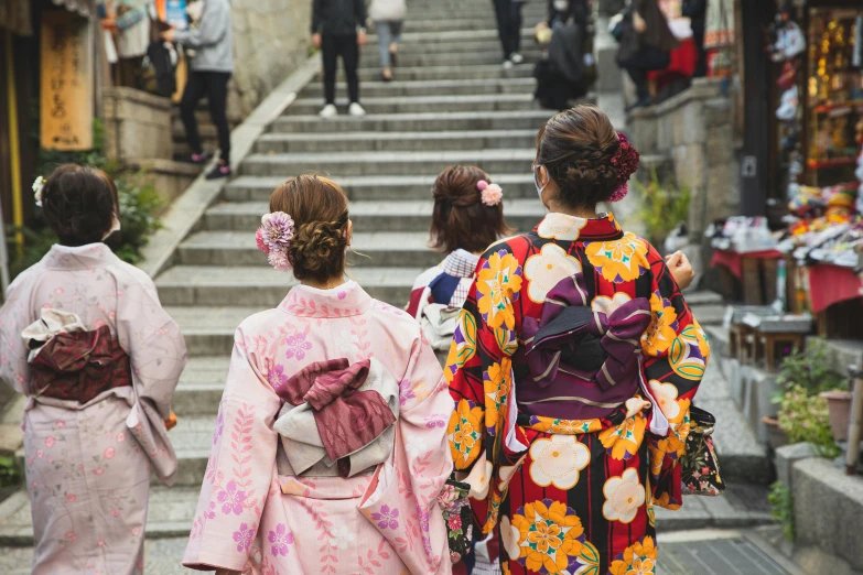 a group of women in kimono walking down a street, trending on unsplash, sitting on temple stairs, geisha hairstyle, 🦩🪐🐞👩🏻🦳, wearing pink floral chiton